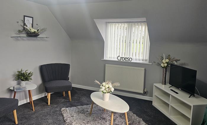 The Redford Cwtch Lounge – a cosy, welcoming space with soft seating, warm lighting, and rustic charm, perfect for relaxing with family or friends aft